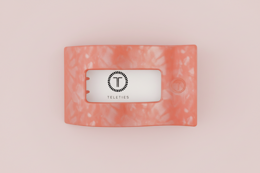 Rectangular pink hair clip on a pink background
