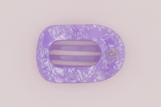 Purple marbled hair clip on a pink background