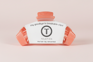 coral hair clip on a pink background