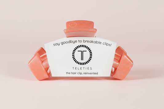 coral hair clip on a pink background