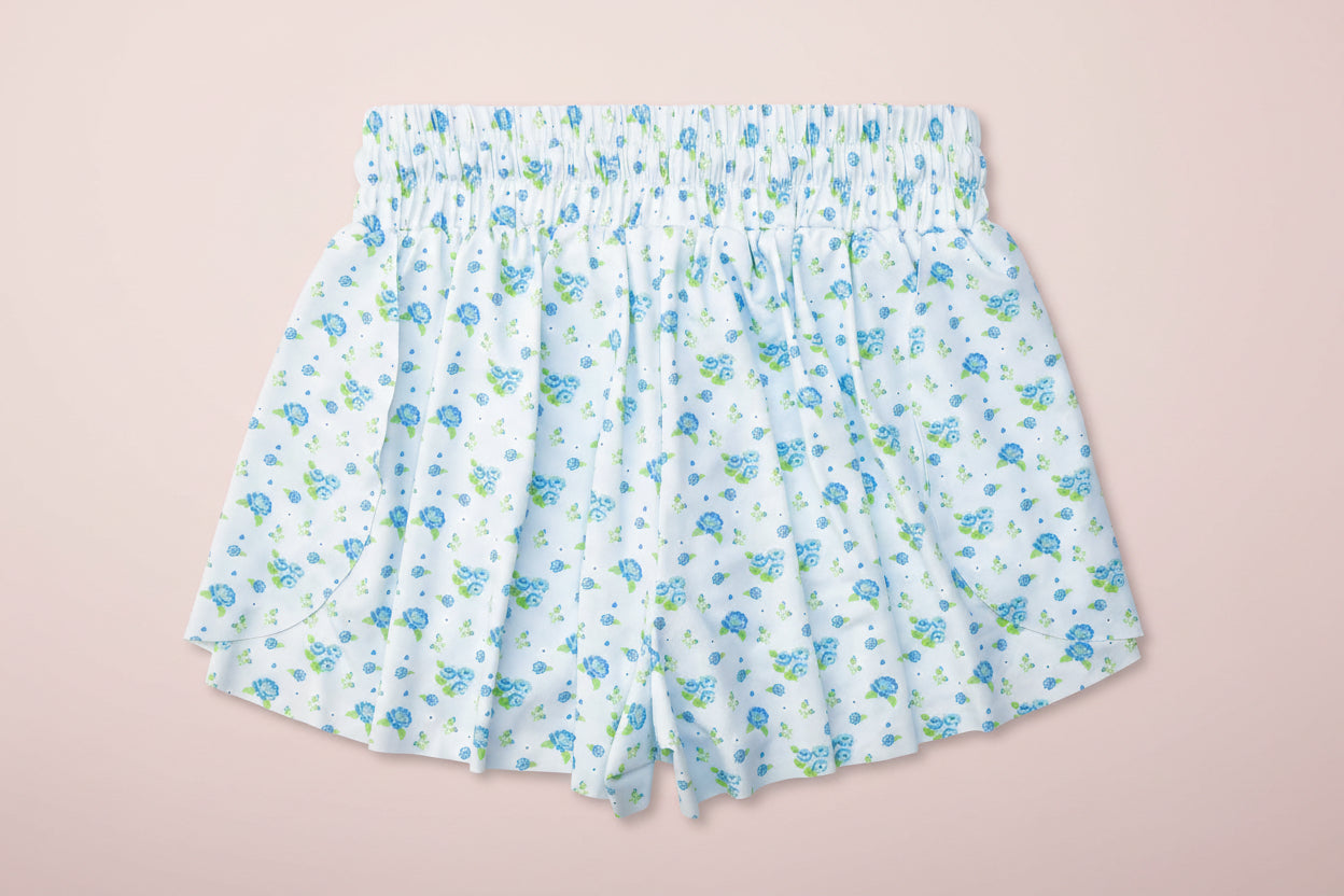 Floral-patterned shorts on a light pink background