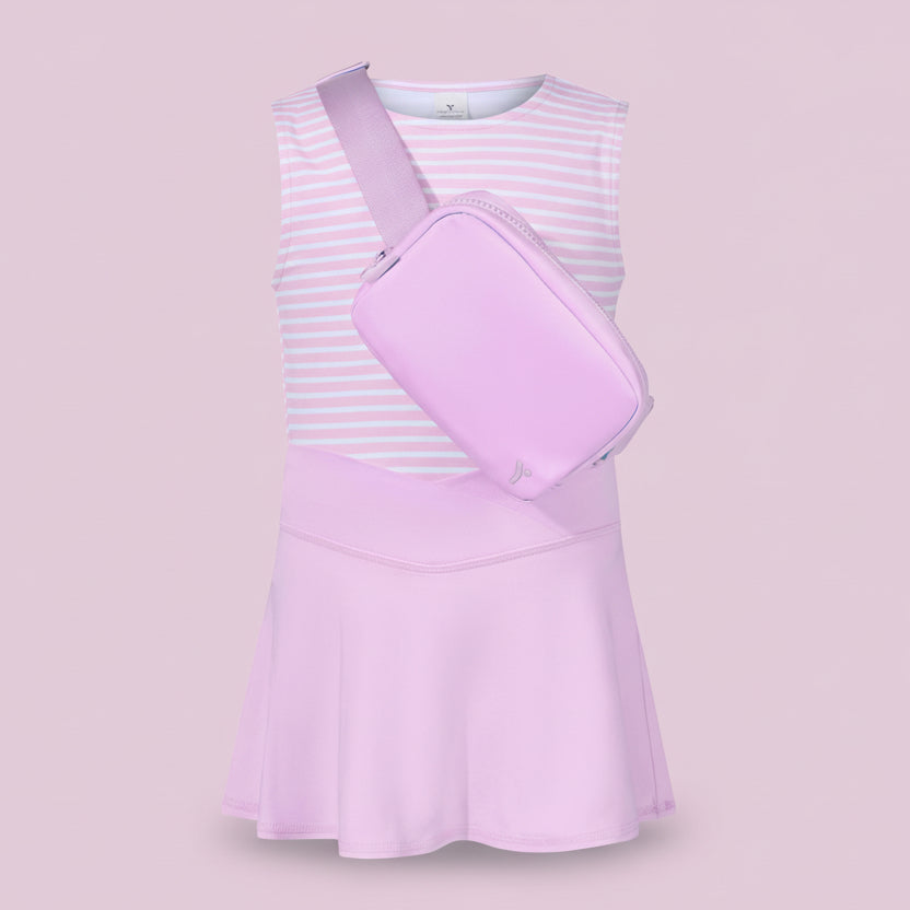 Pink dress with a matching bag on a light pink background