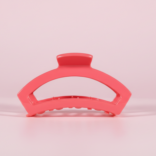 Pink hair clip on a pink background