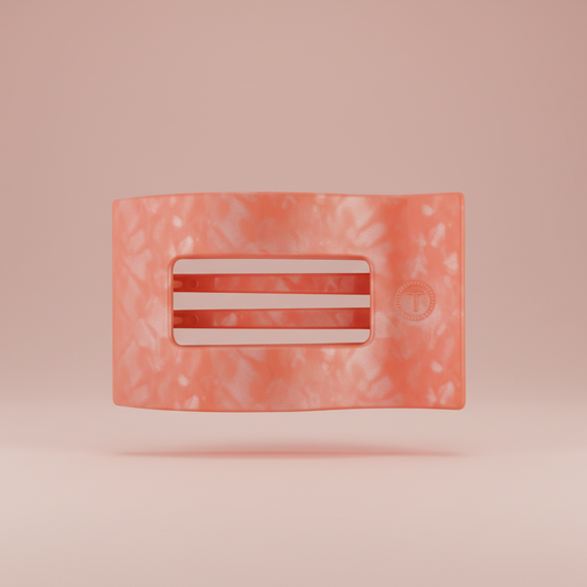 Rectangular pink hair clip on a pink background