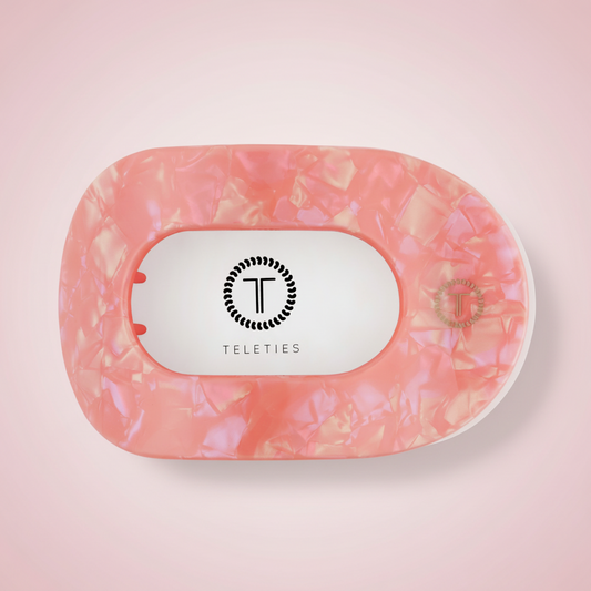 pink hair clip on pink background