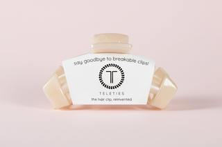 Beige hair clip on a pink background

