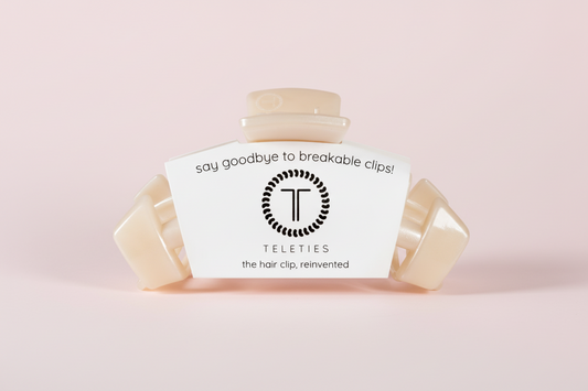 Beige hair clip on a pink background
