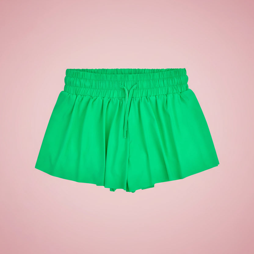 Green shorts on a pink background