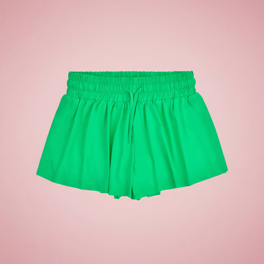 Green shorts on a pink background