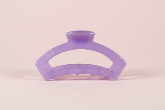 Purple hair clip on a pink background