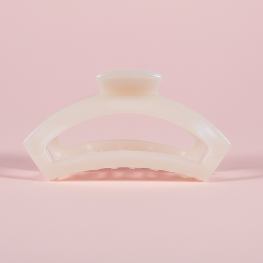 White hair clip on a pink background