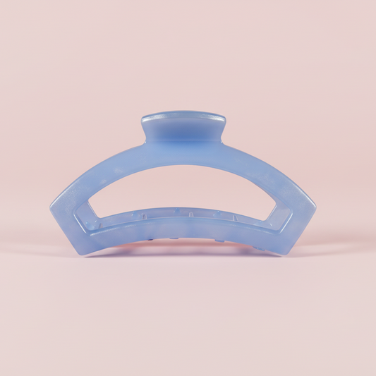 Blue hair clip on a pink background