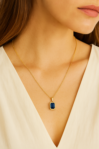 Woman wearing gold birthstone pendant necklace 