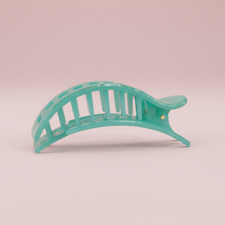 Green marbled hair clip on a pink background