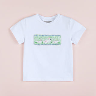 White t-shirt with a colorful graphic on a pink background