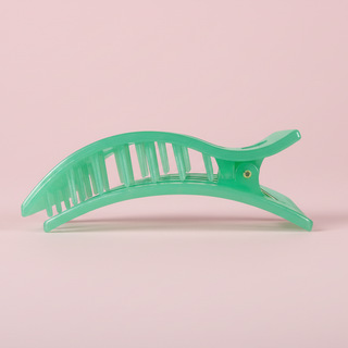 Green marbled hair clip on a pink background