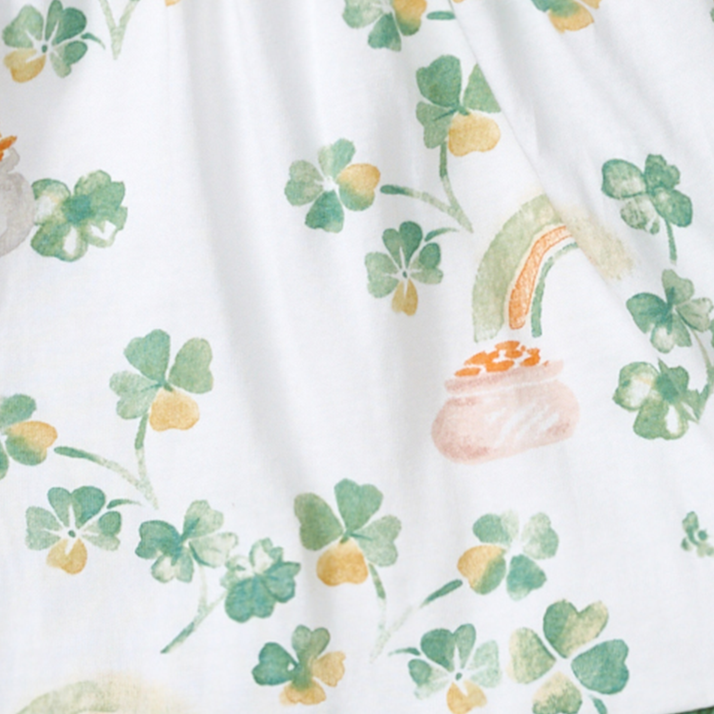 Fabric with shamrock and pot of gold pattern on a white background